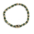 Hamsa Hand and Evil Eye beaded bracelet with green textured stones and golden metal beads - Dark Green (BE866GD00)