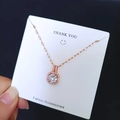 Detail view of rose gold necklace with square zircon pendant on display card - Rose Gold/White Zirconia