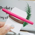 Close-up of bright pink glossy hair clip on a display card with a smooth lacquer finish - Bright Red