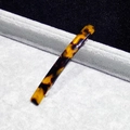 Close-up of tortoise shell pattern acetate hair clip with a silver metal spring clasp - Coffee Leopard