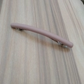 Detailed close-up of matte dusty rose hair clip with silver metal spring base - Orange Pink
