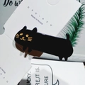 Close-up of black acetate cat hair clip with gold whiskers on a branded white card - Solid Black Cat Style / Black