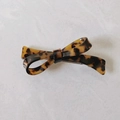 Detailed shot of tortoiseshell acetate bow hair clip with high-quality spring mechanism - Dark Color