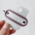 Minimalist purple-grey oval resin hair clip with black metal backing on display card - Lotus Gray