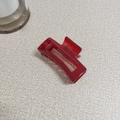 Top view of a translucent burgundy rectangular hair claw clip with internal teeth - Dark Red