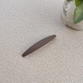 Minimalist matte dark brown long hair clip displayed on a textured beige surface - Brown