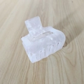 Detail of a large square marble-patterned acetate hair claw clip on a light wooden background - White