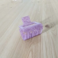 Detail view of purple marble acetate hair claw clip with silver spring on wood - Purple Series