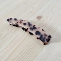 Detailansicht des Schildpattmusters und des geschwungenen Designs dieser Haarspange aus Harz - Heller Leopard