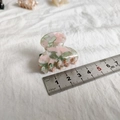 Detail view of a 4cm small marble pattern heart hair claw clip with measuring ruler - Green Pink Floral