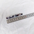 Macro shot of a 10.5cm acetate hair clip with purple marble pattern on a metal ruler - Purple Floral