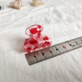 Detail showing a 4cm red and white marble texture small hair claw clip with measuring scale - Red Floral