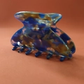 Detail of elegant tortoiseshell acetate hair claw clip with blue and brown marble pattern - Blue Floral