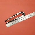 Detail showing a 10cm U-shaped acetate hair pin with black and white cow print texture - Black and White Floral