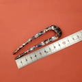 Detailed view of an 11.5cm tortoiseshell acetate U-shaped hair pin on a scale - Black Multi-color Pattern