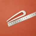 Macro view of a 10.5cm acetate U-shaped hair pin showing elegant white marble texture - White Floral Pattern