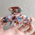 Detail showing the tortoiseshell marble pattern on a medium acetate hair claw clip - Brown Coffee