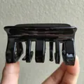 Detail of a large glossy black rectangular hair claw clip with strong teeth for thick hair - Black