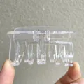 Detailed view of large transparent acrylic hair claw clip with strong gold metal spring - Clear White