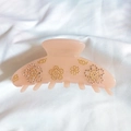 Detail of pink floral claw clip featuring rhinestone inlays and golden bead patterns - Orange Pink