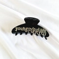 Detail shot of black resin hair claw with young forever lettering in white rhinestones - Black Single Sided Rhinestone