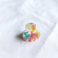 Close-up of small acetate hair claw clip with colorful marble pattern and smooth resin texture - Colorful Pattern