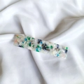 Detailed close-up of a colorful mosaic acetate spring hair clip on white silk fabric - 23# Green White System