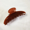 Detailed view of a 12cm amber brown acetate claw clip with a glossy translucent finish - Amber Brown