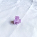 Detailed macro view of a purple mini acetate hair claw with elegant marble texture - Light Purple