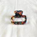Detailed macro view of small rectangular acetate claw clip with colorful marble pattern - Multicolor Series