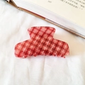 French vintage red and white checkered acetate hair claw clip on white fabric surface - Red Plaid