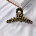 Large acetate hair claw clip featuring classic tortoiseshell pattern and golden highlights - Black Coffee