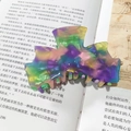 Tie-dye acetate hair claw clip with purple, yellow and green marble effect on book - Emerald Green Series