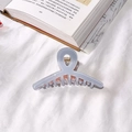 Elegant pale blue translucent acetate shark hair claw clip on white fabric background - Blue & Pink