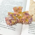 Large acetate hair claw clip with colorful marble pattern and strong spring hold - Yellow Purple Tones