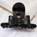 Sparkling black acetate bow hair claw clip with silver glitter finish for elegant styling - Black