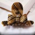 Elegant tortoise shell patterned bow hair claw clip made of polished acetate for women - Brown Textured Pattern
