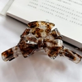 Brown tortoise shell bow hair claw clip in acetate finish on white fabric - Coffee White