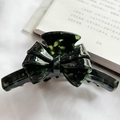French acetate bow hair claw clip in dark green tortoiseshell pattern on a vintage book - Dark Green