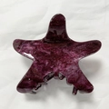 Detailed view of starfish hair claw with purple marble texture and gold glitter accents - Dark Purple