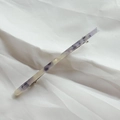Detailed macro view of the marble patterned acetate hair clip with silver spring metal back - Fresh Blue