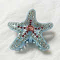 Pinza de pelo de estrella de mar en resina jaspeada azul claro con pedrería rosa y brillo - Azul