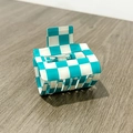 Macro detail of checkered square hair claw with light blue and white pattern - Blue White Checkered