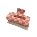 Macro shot of pink and cream checkered hair claw clip with glossy acrylic finish - Pink Grid