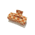 Detailed view of the square orange and beige checkered pattern claw clip with glossy finish - Orange Gingham