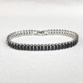 Detail of classic silver tennis bracelet featuring rectangular black cubic zirconia stones - Platinum Color Black Zirconia