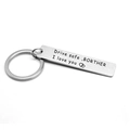 Macro shot of brushed stainless steel keychain with engraved Drive safe message for brother - Brother