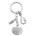 Detailed macro view of stainless steel keychain charms with fish, hook and engraved quote - Round Tag Style (xk240-13)