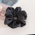Detailed view of large dark grey denim texture hair scrunchie with FMared logo label - Gray