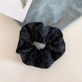 Detailed view of a vintage dark blue paisley scrunchie made of wool fabric on a white desk - Navy Blue Paisley Scrunchie